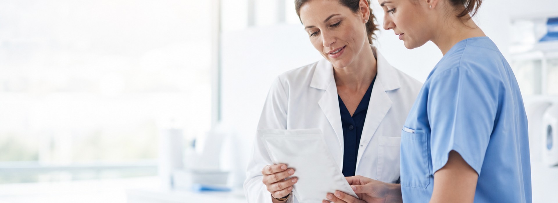 Two clinicians checking a dressing pouch